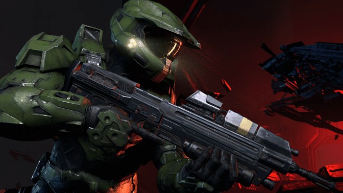 Master Chief in green Spartan armor holding an assault rifle in Halo Infinite