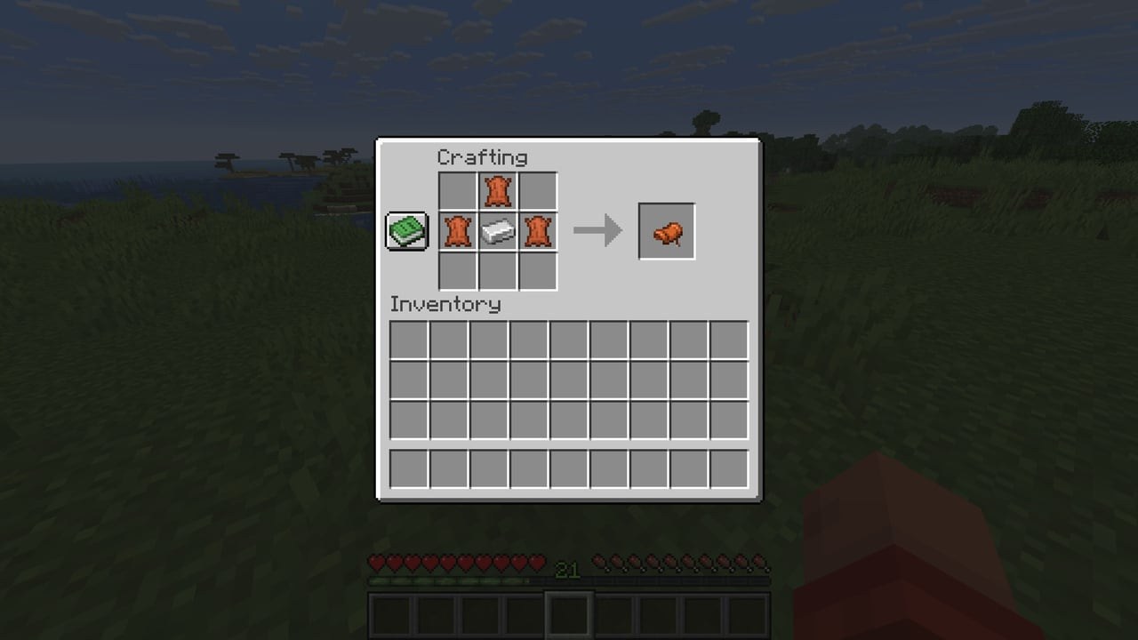 Minecraft crafting grid with three leather around an iron ingot making a saddle