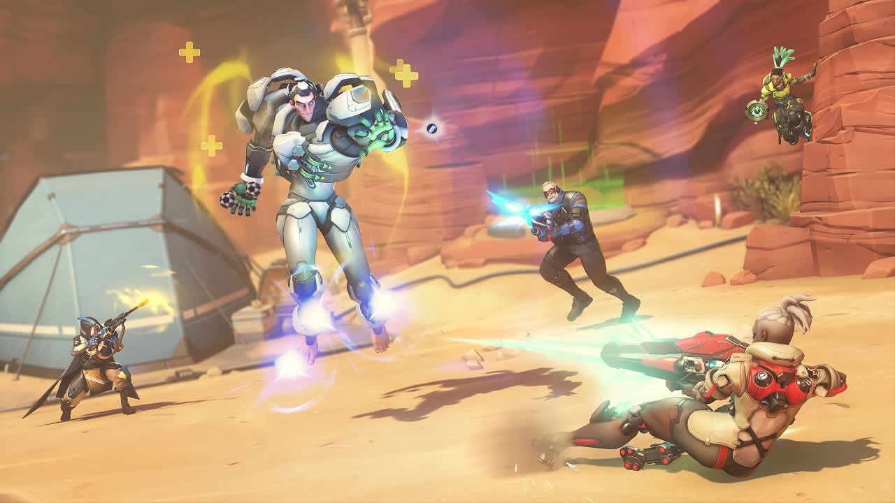 Overwatch heroes fighting on a sunlit desert canyon map